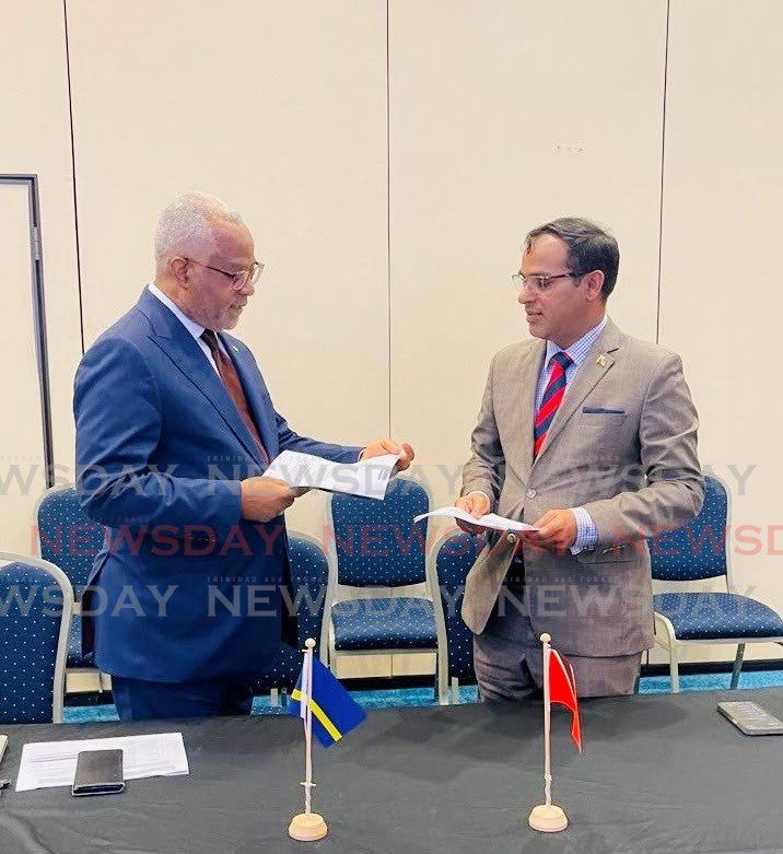 PARTIAL-SCOPE TALKS: Dr Caryl Monte, president, Permanent Commission for International Trade and Foreign Economic Relations, Curacao, left, in conversation with Randall Karim, permanent secretary, Ministry of Trade, at the first round of negotiations for the PSTA between TT and Curacao. -
Photo courtesy MTI