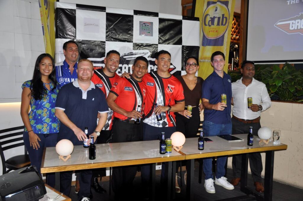 TT Powerboat Association president Jonathan Tardieu, middle, along with other officials, sponsors and supporters the 56th TT Great Race launch at Luna Bar, West Mall, on July 18. PHOTO BY RONALD DANIEL - Ronald Daniel