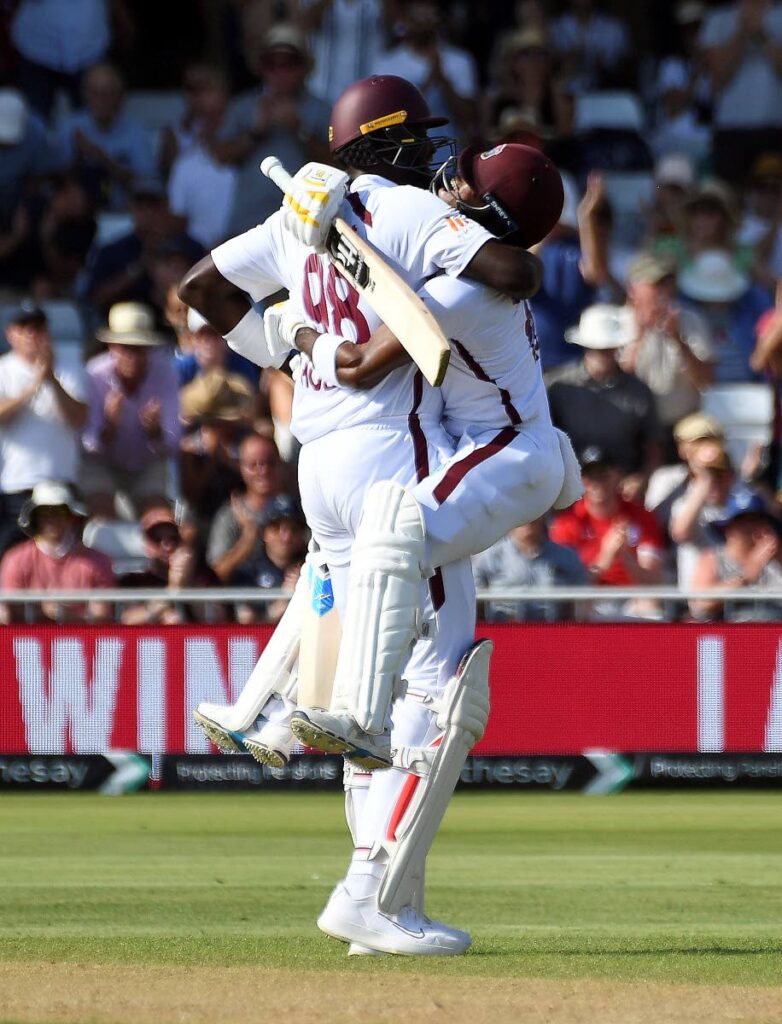 West Indies batsman Kavem Hodge, right, celebrates after scoring a century with team-mate Jason Holder during day two of the second Test between England and West Indies at Trent Bridge cricket ground in Nottingham, England, on Friday. AP PHOTO - 