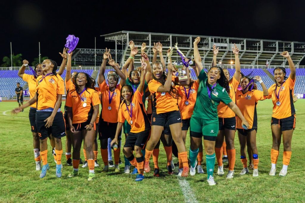 Club Sando women celebrate their victory of the Defence Force Women Warriors Wellness football tournament final match at the Hasely Crawford Stadium on July 19 in Mucurapo. Club Sando defeated Defence Force 2-1. - Photo courtesy Daniel Prentice