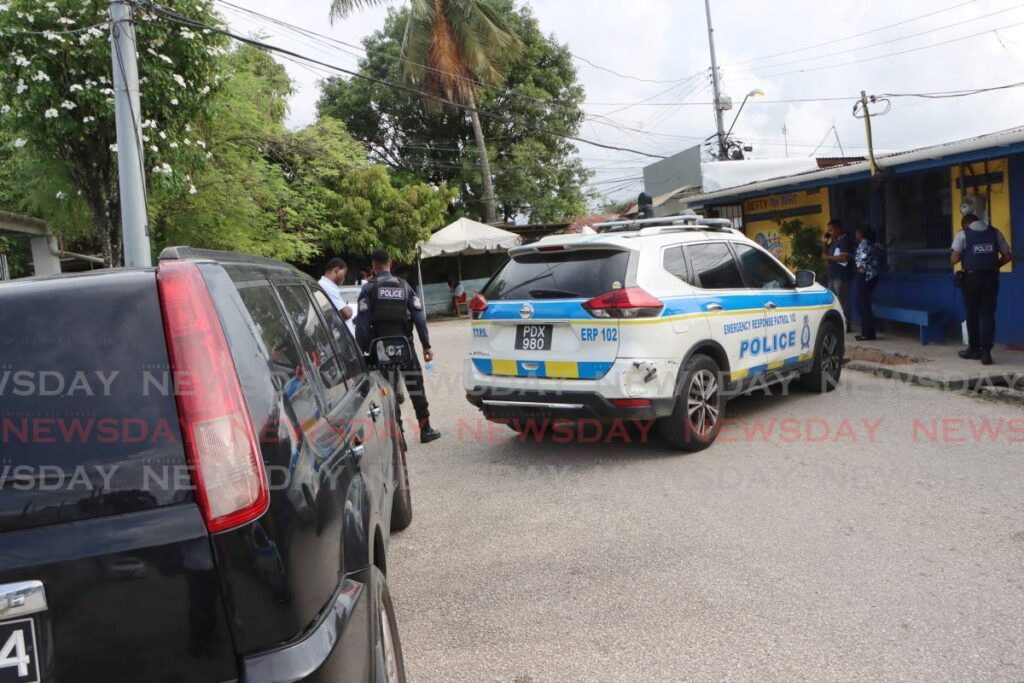 Police secure the scene of a shooting at Phase 4, Beetham Gardens, on Monday afternoon. - Angelo Marcelle