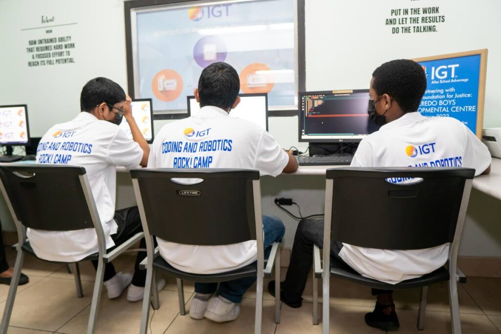 Students deeply engrossed in mastering new tech skills at the IGT Coding and Robotics Rock! camp. 
Photo courtesy IGT - 