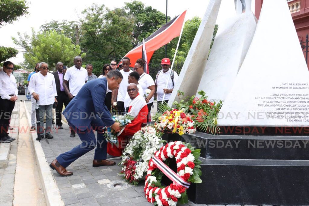 Gary Griffith, political leader of NTA lays a wreath in memorium of the attempted coup victims in front of the cenothaph at the Red House , Abercromby Street, Port of Spain, on July 27. - Faith Ayoung