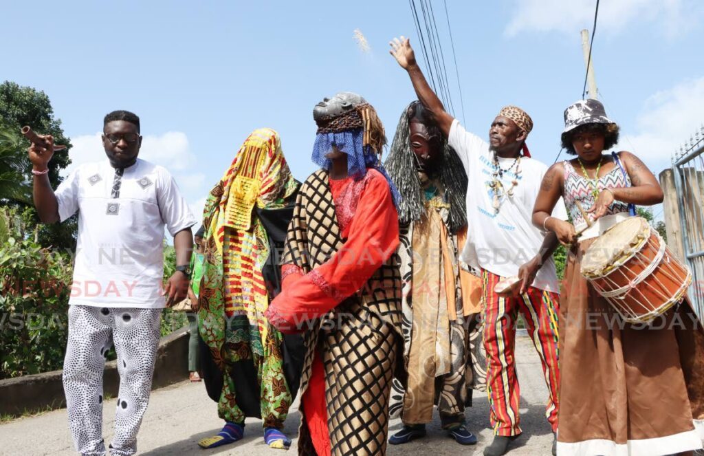 Members of the Omo Ododuwa Institute during the Heritage Masquerade Festival at Petit Curacaye, Santa Cruz Old Road.  - Photo by Ayanna Kinsale 