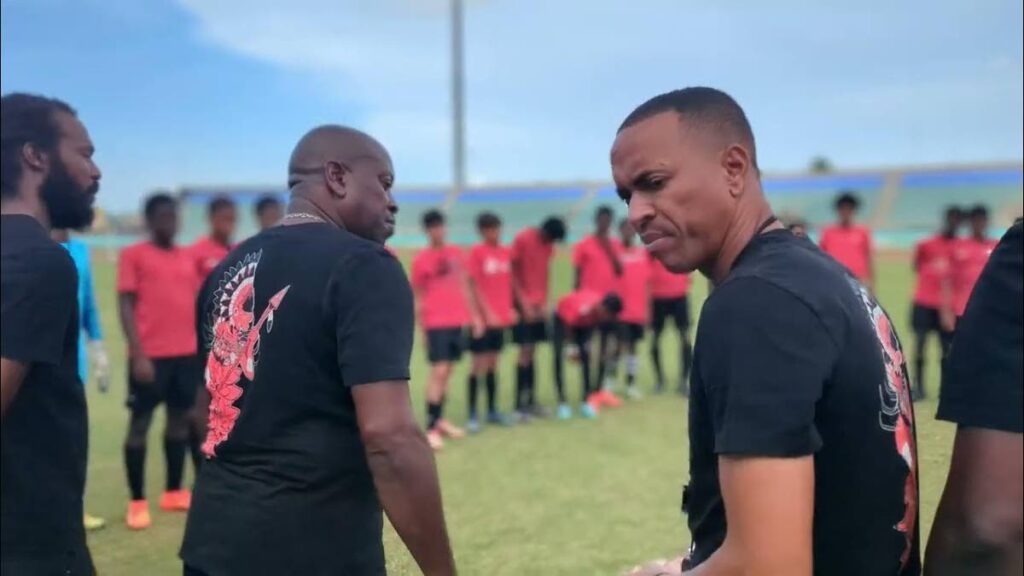 TT U14 coach Densill Theobald, right, with other officials before addressing the national U14 team. They are preparing for the CFU U14 tournament which kicks off in Tobago from August 16-25.  - Photo Courtesy TTFA