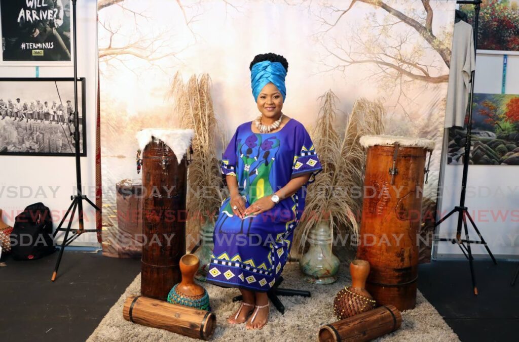 EDUCATED POSE: Minister of Education Dr Nyan Gadsby-Dolly, cuts a striking figure at the Photo Majic booth at the Lidj Yasu Omowale Emancipation Village, Queens Park Savannah on July 31. - Photo by Venessa Mohammed