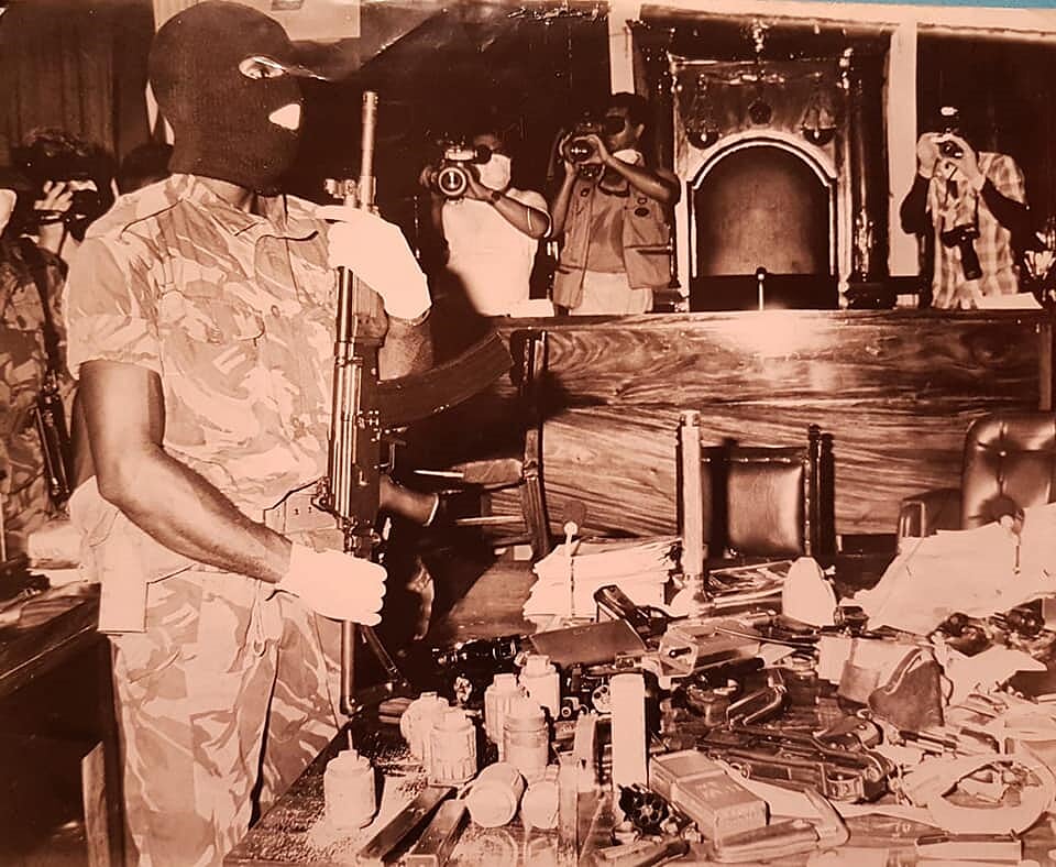 A masked soldier stands guard in the chamber of the Red House after insurgents surrendered on August 1 1990. PHOTO COURTESY TT REGIMENT ARCHIVES