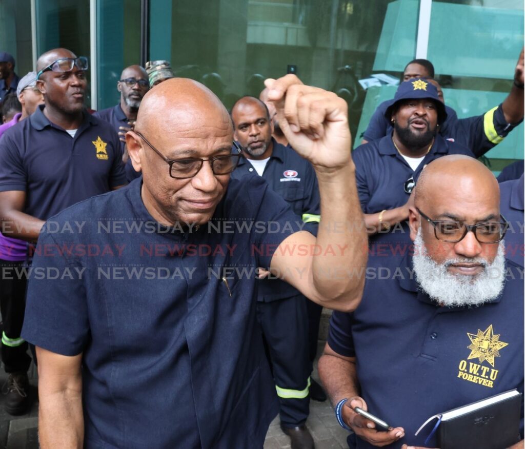 OWTU president general Ancel Roget, left, and OWTU research and education officer Ozzi Warwick, deliver a letter addressed to Energy Minister Stuart Young at the ministry's head office at Tower C, International Waterfront Centre, Port of Spain on July 30. - Photo by Roger Jacob