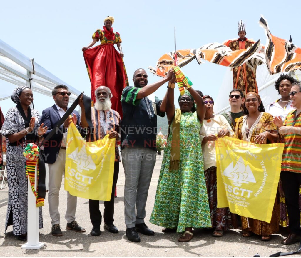 Mayor of Port of Spain Chinua Alleyne, centre, and Chair of the Emancipation Support Committee Zakiya Uzoma-Wadada cut the ribbon to open the event on July 27. - Photo by Ayanna Kinsale