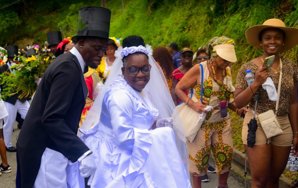 The procession of the bride and groom makes its way along the streets of Moriah on July 20.  - Photo courtesy Visual Styles