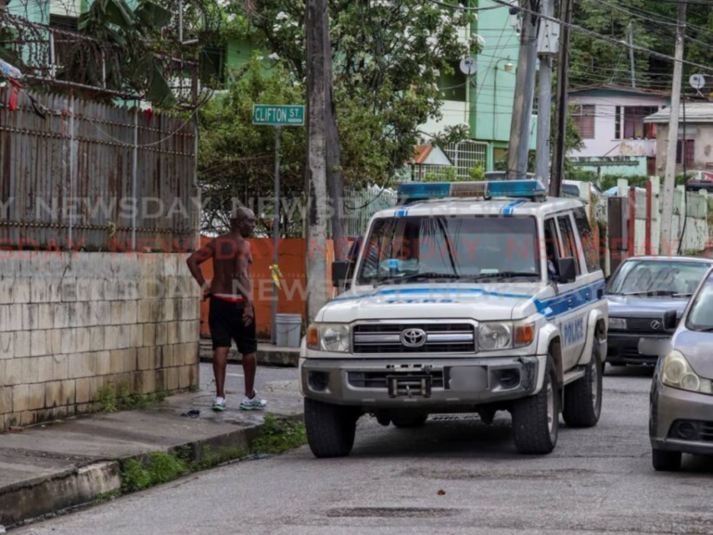 Police speak to a resident while on patrol on St Paul Street, Port of Spain, on July 24. - Photo by Gabriel Williams