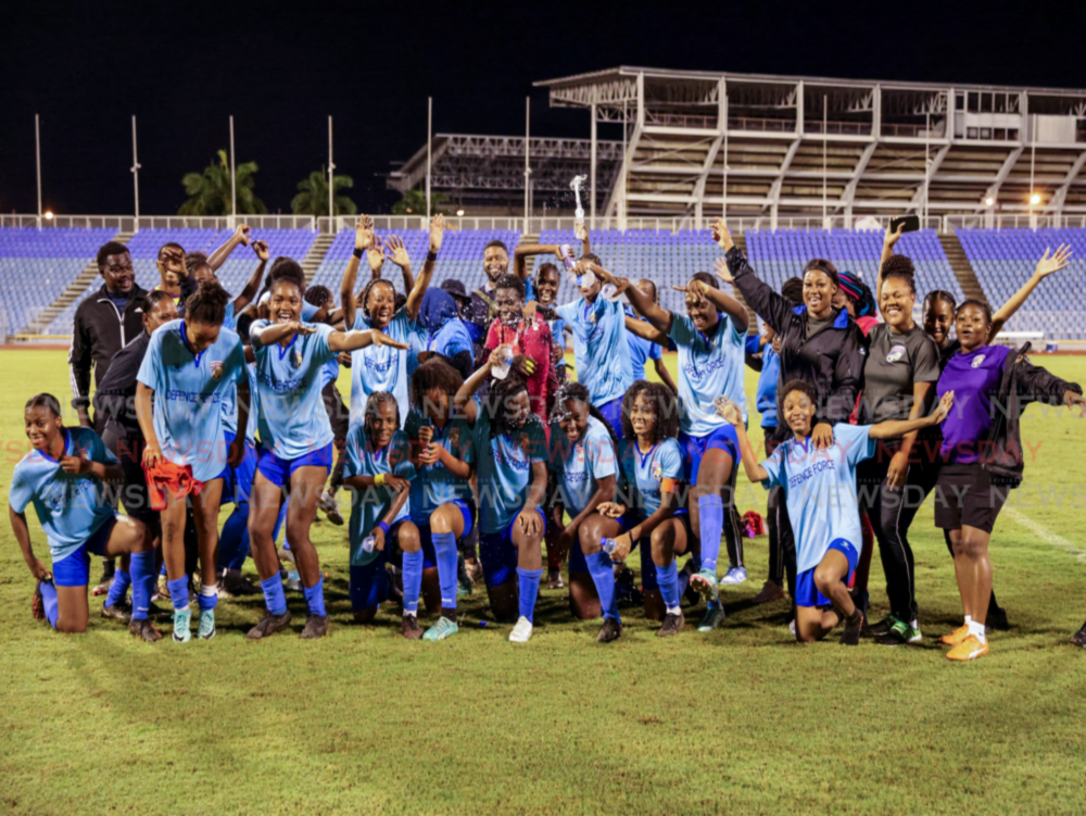 Defence Force FC women celebrate after their victory against Club Sando in the TTWoLF Conference Knockout Cup final match at the Hasely Crawford Stadium on Monday night in Port of Spain.  - Photo by Daniel Prentice 