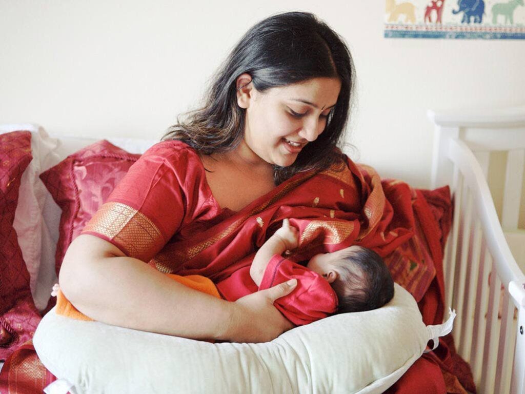 A woman breastfeeds her baby. NCRHA will host events in August to encourage more mothers to breastfeed. - 