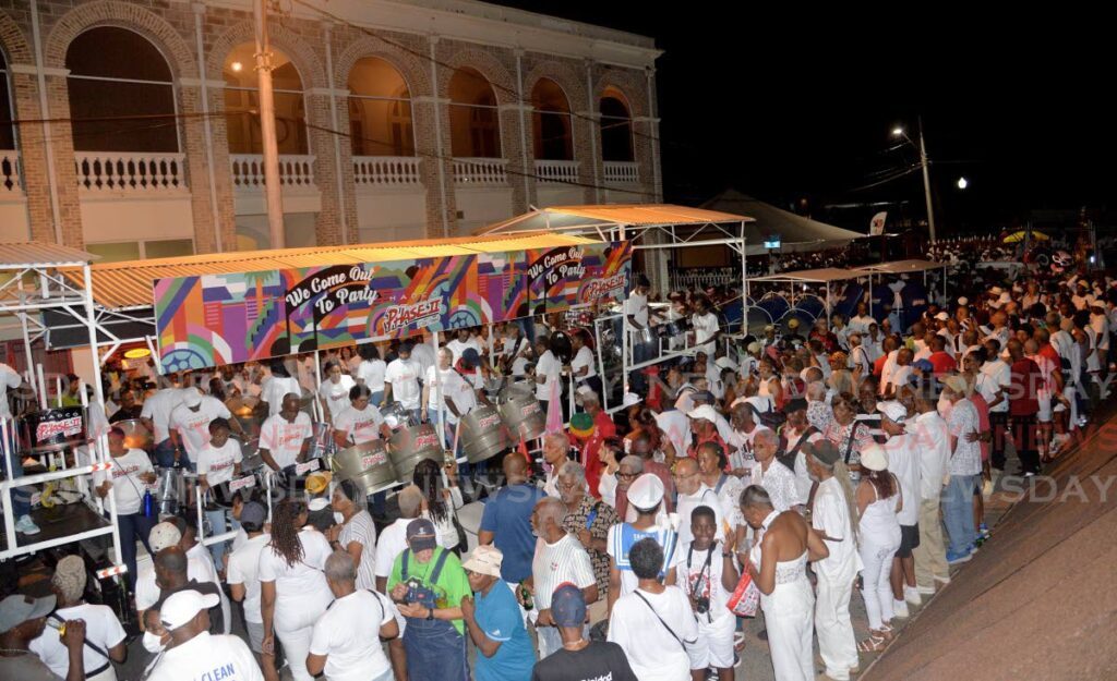 Spectators enjoy the music of Hadco Phase II Pan Grove during  Pan Trinbago's Pan and Powder Parade on Prembroke Street, Port of Spain on August 23, 2023. Many events during pan month draw thousands of people to them, like the Pan and Powder parade through Port of Spain.  - 