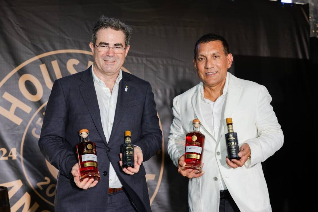 Angostura's CEO, Laurent Schun, left and chairman Terrence Bharath SC, reveal its 200-year anniversary limited edition bitters and redesigned premium rum range.
Photo courtesy Angostura - 