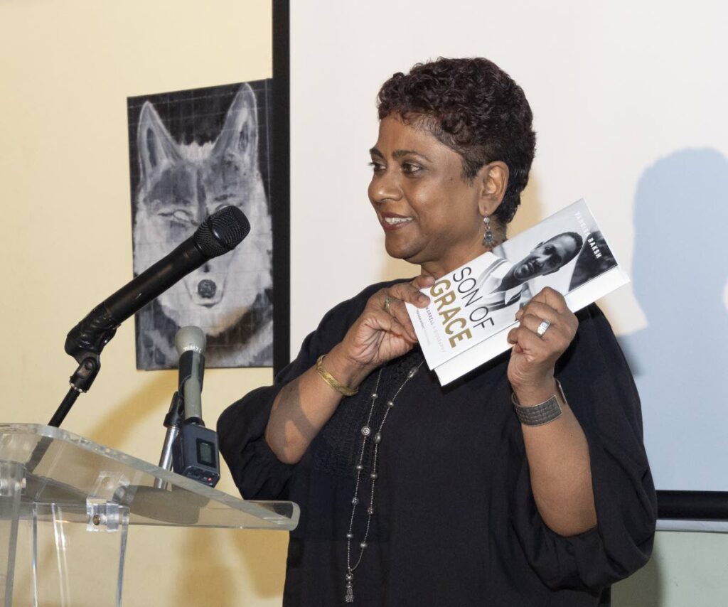 Vaneisa Baksh holds up a copy of Son of Grace at its launch on April 23 at the Dalai Llama, One Woodbrook Place, Port of Spain. - Photo courtesy Marlon Rose 