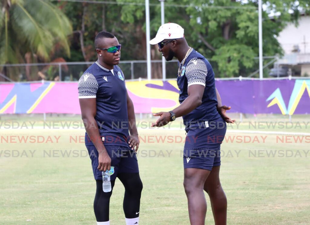 FILE PHOTO: West Indies coach Daren Sammy, right, speaks with West Indies T20 captain Rovman Powell.  - AYANNA KINSALE