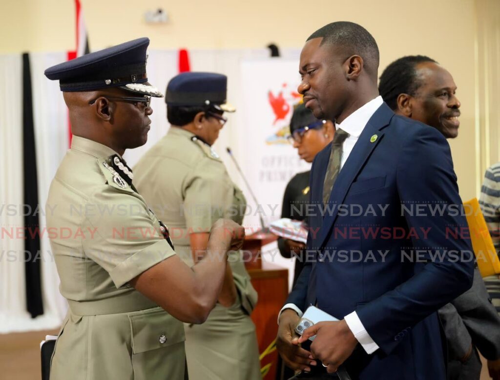 Chief Secretary Farley Augustine, right, chats with Deputy Commissioner of Police (Operations) Junior Benjamin at a post-National Security Council meeting news briefing at the Office of the Prime Minister, Central Administrative Services Tobago in Scarborough on July 9. File photo by Visual Styles