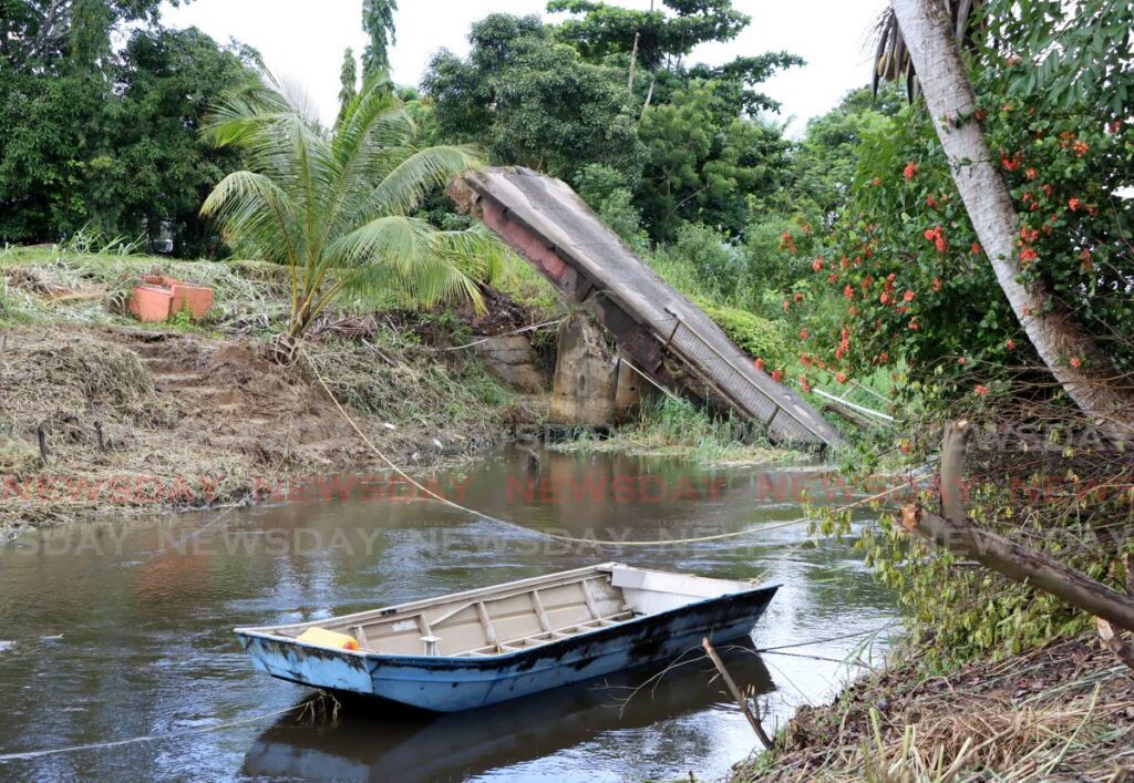 A boat remains in the water to assist marooned residents after the bridge collapsed at St John's Branch Trace, Fyzabad. - File photo by Ayanna Kinsale