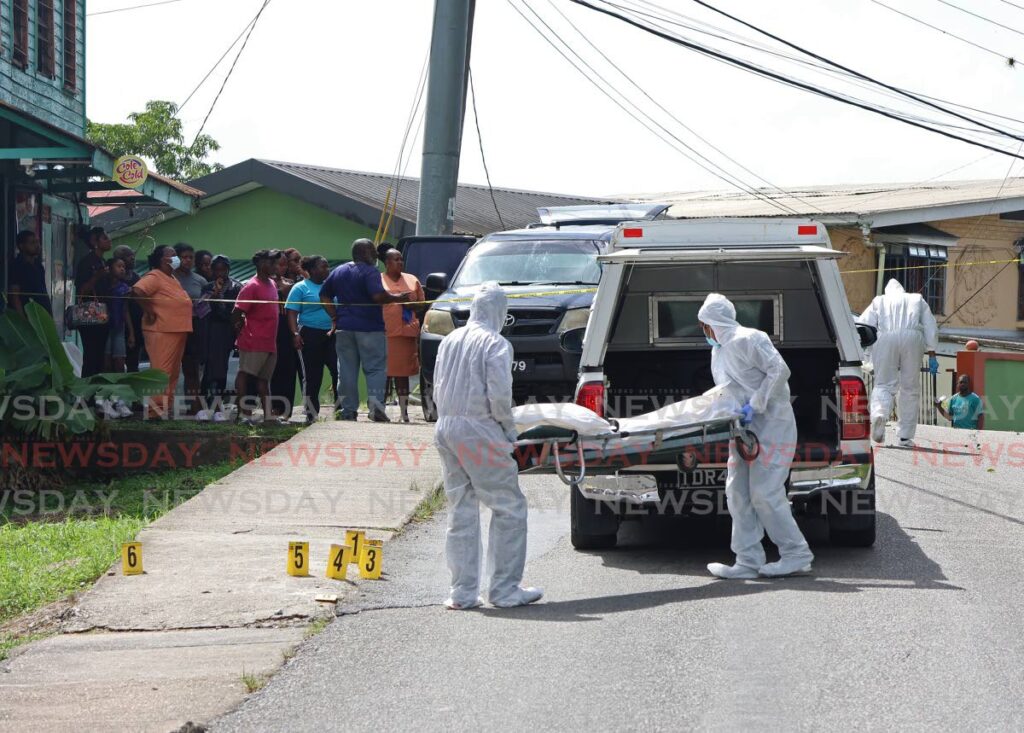 Undertakers remove the body of Prince Ralph Maingot, 35, who was shot dead at his home in Delhi Road in Fyzabad on July 24.-  File photo by Venessa Mohammed