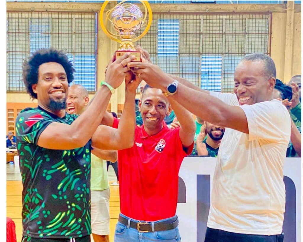 Proman captain Hayde Stewart (left) is presented with the Corporate Futsal trophy by TT Football Association third vice-president Jameson Jr Rigues and Tunapuna MP Esmond Forde. - Photo courtesy 868 Futsal