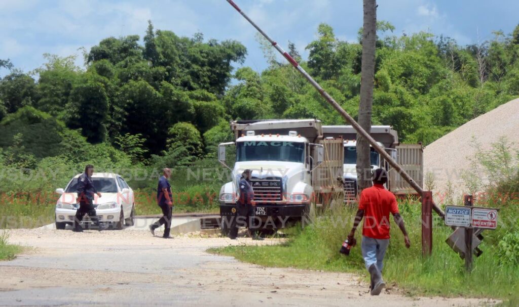 Police at the Warner Group of Companies aggregate mining plant at Moonan Road in Wallerfield on July 31. - File photo