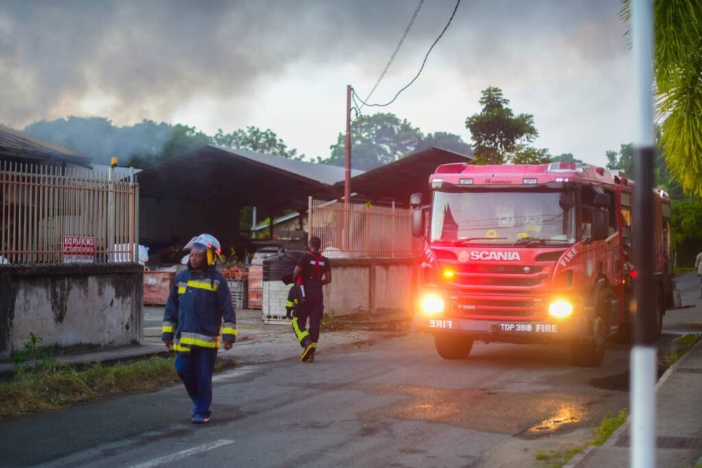 Firefighters respond to an arson attack at Dave Discount Hardware in Canaan, Tobago, on Friday. - Photo by Visual Styles 