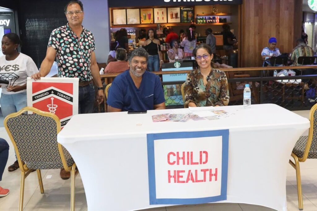 Dr Ravi Maharaj, left, Dr Ricardo Naraynsingh, and paediatrician, Dr Robyn Ramsingh gives advice on child health at the health fair held at Gulf City Mall. - 