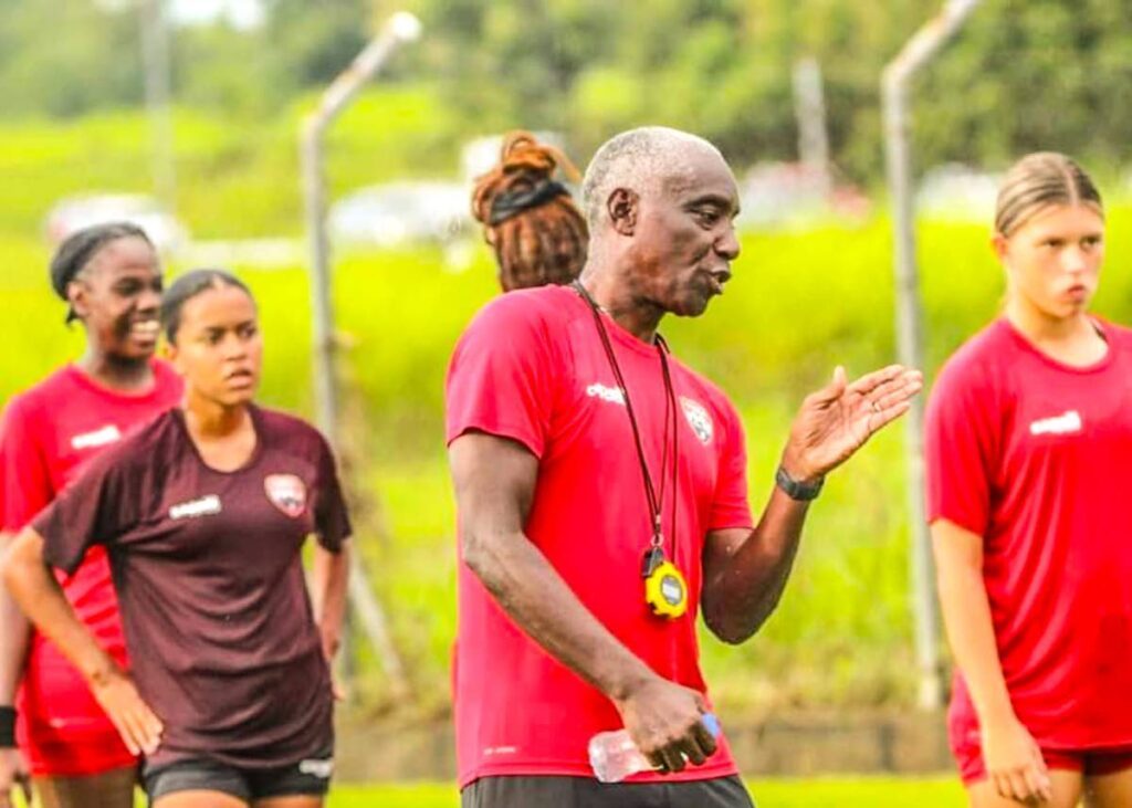 TT Under-15 girls' football team coach Marlon Charles relays instructions during a training session. Photo courtesy TTFA.  - 