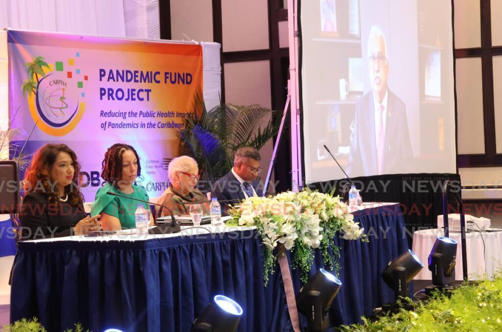 At right, Health Minister Terrence Deyalsingh appears by video link as, from left, Carpha interim executive director Dr Lisa Indar, IDB country representative Carina Cockburn, Caricom assistant secretary general Alison Drayton and Carpha coporate services director Dr Mark Sami conduct a regional stakeholder consultation workshop on the Pandemic Fund Project at the Hilton Trinidad, St Ann’s, on August 5. - Photo by Roger Jacob