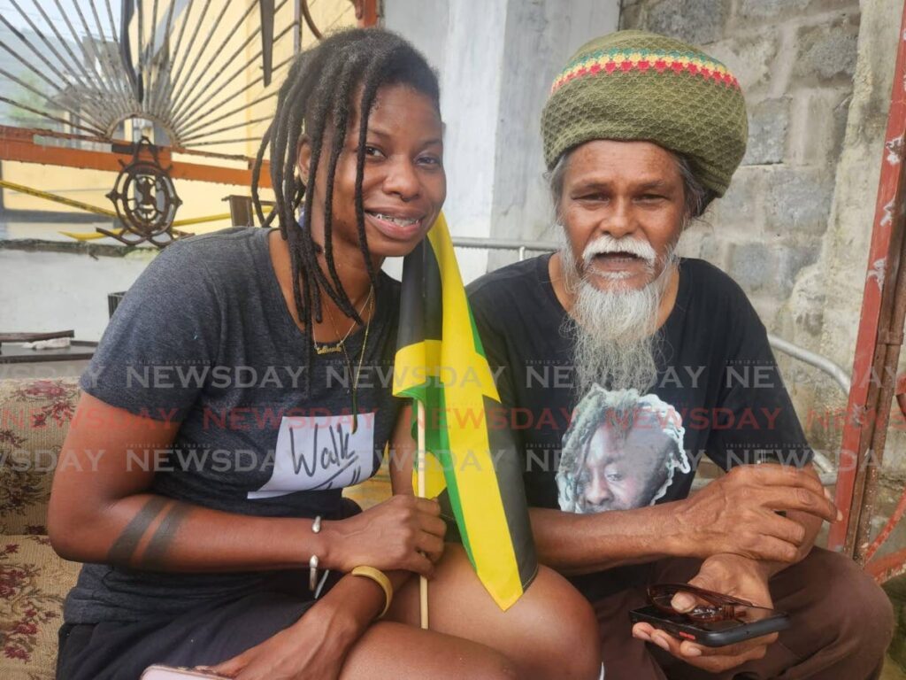 Jamaican Simone Harris, left, and Junior Bishnath at his school Kaisokah School of the Arts in San Fernando. Harris came to TT to learn the art of stilt walking which is part of her Maroon ancestry. - Photo by Yvonne Webb