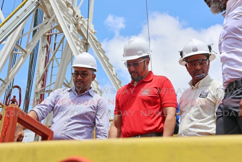 From left, Sydeali Khan, campus manager at NESC Ste Madeleine drilling academy makes a point to energy minister Stuart Young and NESC president Kern Dass during a tour of the drilling rig at the Ste Madeline campus. - Photo by Lincoln Holder 