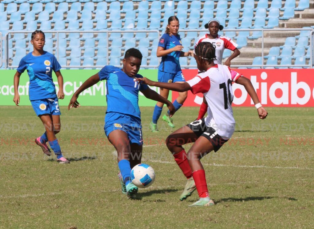 Curacao's Xialeahmay Martis Nocento kicks the balls while under pressure from TT's Mikalah Guerero (R) during the Concacaf Girls Under-15 Championship match, at the Hasely Crawford Stadium, Port of Spain, on August 6, 2024. - Roger Jacob