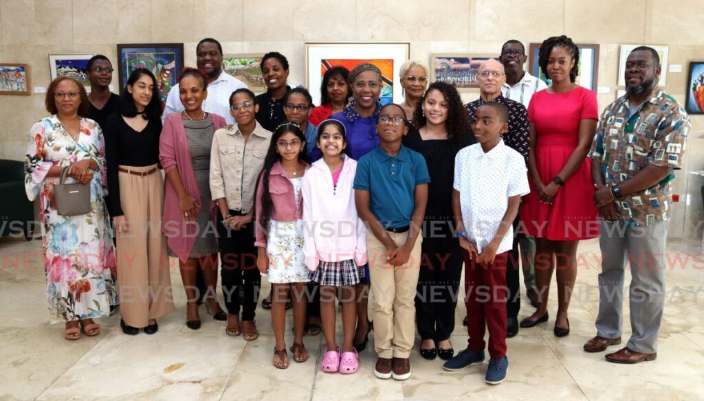 Speaker of the House Bridgid Annisette-George gathers with several of the exhibiting artists at the  Percussion - The Sounds of Steelpan exhibition at the Rotunda Gallery on August 7.  - Photo by Gabriel Williams