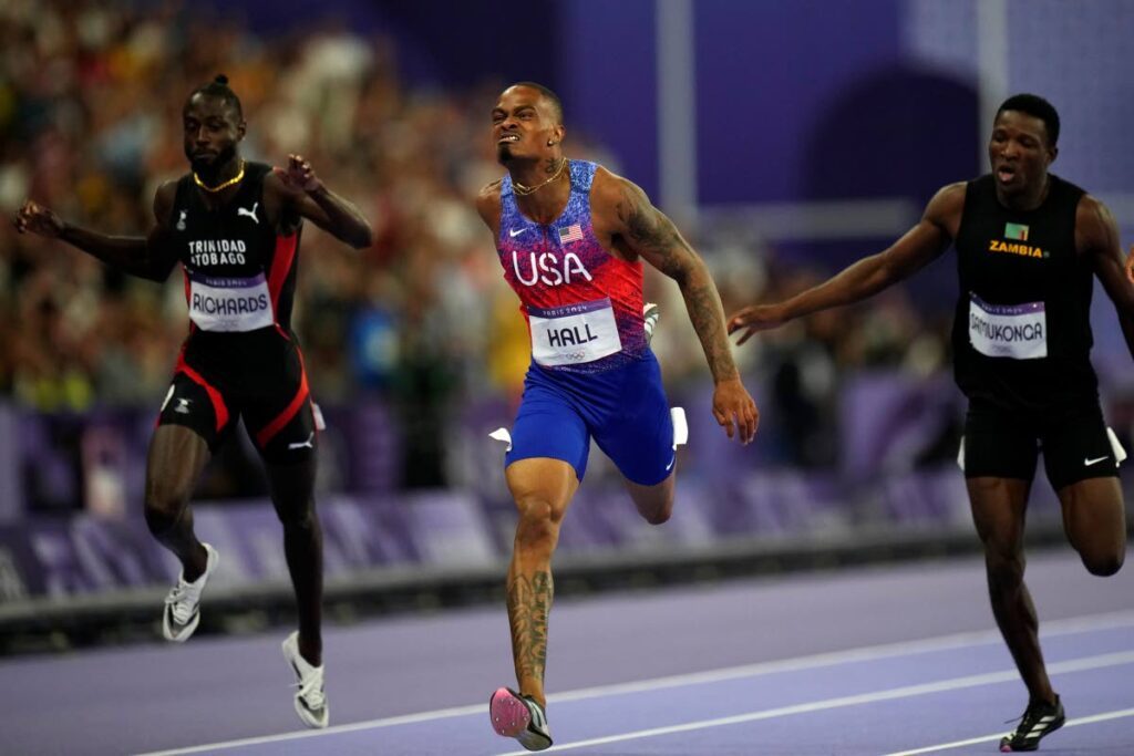 Trinidad and Tobago sprinter Jereem Richards, left, finishes a national record-breaking run in the finals of the 400-metre sprint in fourth position at the 2024 Summer Olympics in Paris France on August 7, 2024. Also in photo are gold-medal winner Quincy Hall of the US, centre, and bronze-medal winner Muzala Samukonga of Zambia. England’s Matthew Hudson-Smith took home the silver medal. - AP PHOTO