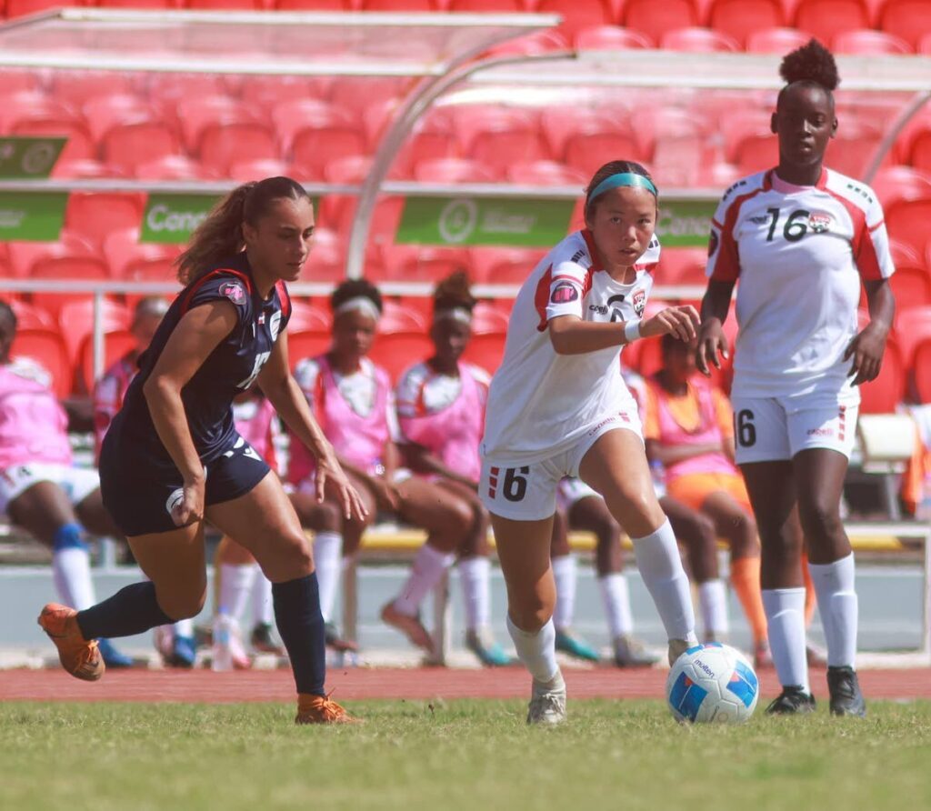 TT under-15 girls' football team midfielder Mia Lee Ching (C) looks for a pass against Dominican Republic during the League B semifinal of the Concacaf Girls' Under-15 Championships at the Hasely Crawford Stadium in Mucurapo on August 9. - Photo courtesy TTFA