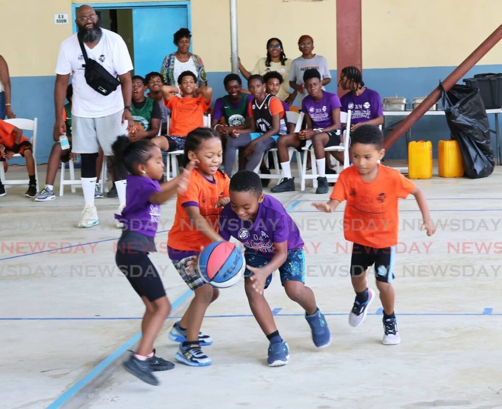 Children play during the Score Big Basketball Camp at the Iere High School in Siparia recently. - Photo by Lincoln Holder 