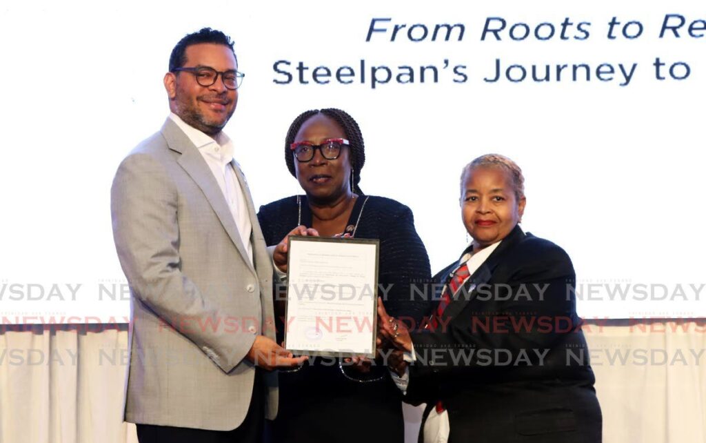 From left, Minister of Tourism, Culture and the Arts Randall Mitchell, Pan Trinbago president Beverly-Ramsey Moore, and Pan Trinbago secretary Denise Hernandez, show off a TT steelpan geographical indication (GI) certificate received by the Intellectual Property Office, at the World Steelpan Conference held at the Hyatt Regency, Port of Spain on August 9. - Photo by Venessa Mohammed