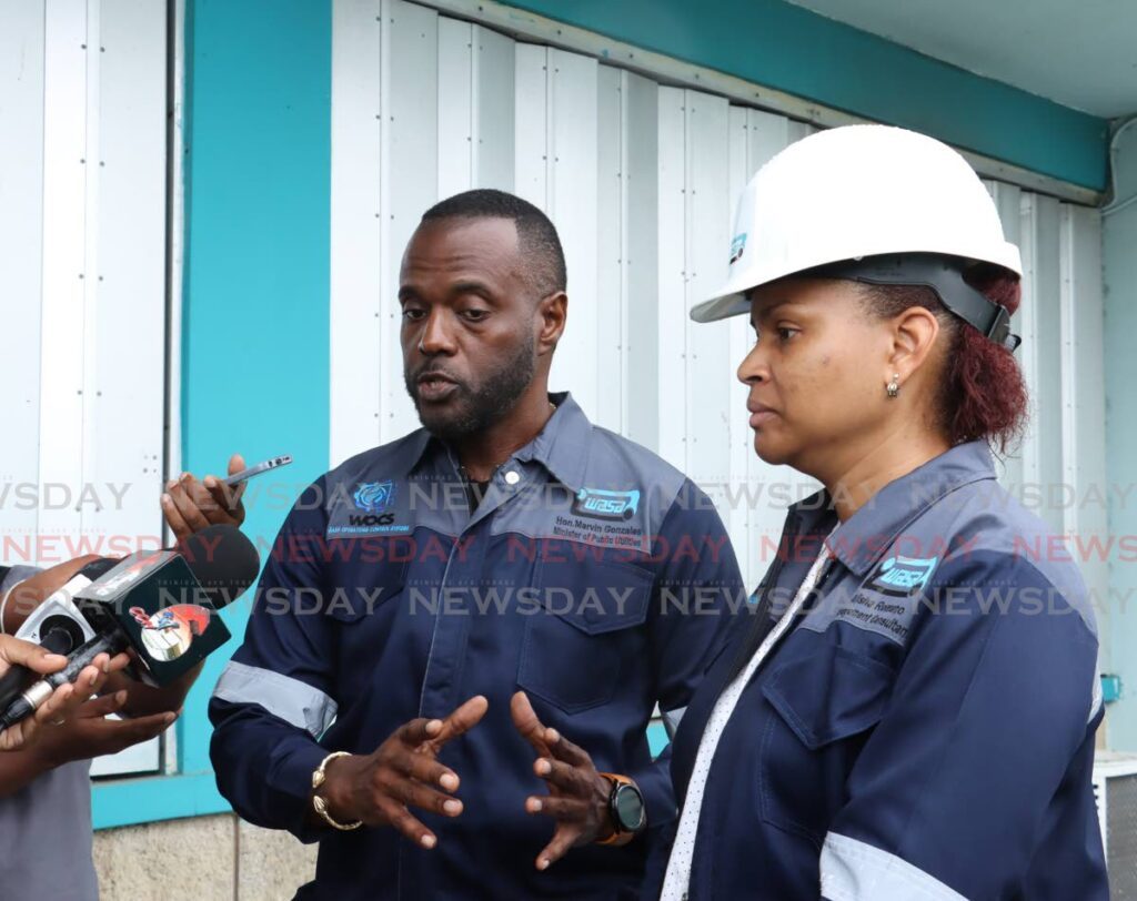 Public Utilities Minister Marvin Gonzales and Alisha Romano, acting director corporate communications, Water and Sewerage Authority (WASA), speak to the media on August 10. - Photo by Faith Ayoung