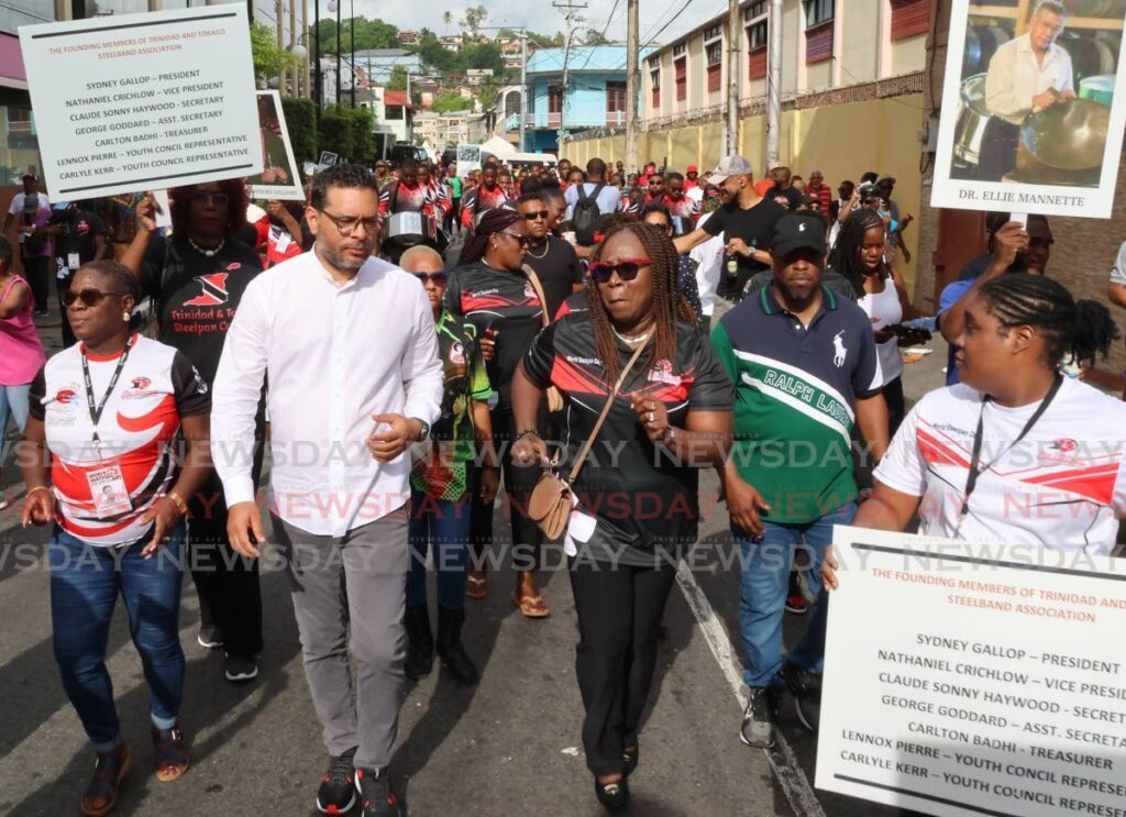 Tourism Minister Randall Mitchell and Pan Trinbago president Beverly Ramsey-Moore led the ancestral walk from Massy Trinidad All Stars Steel Orchestra's panyard to Woodford Square as part of World Steelpan Day on August 11. - Photo by Roger Jacob