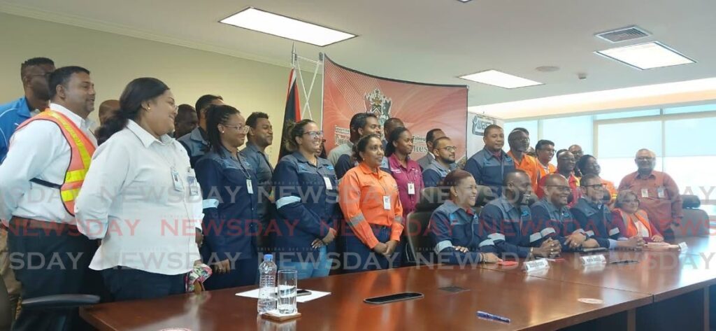 Public Utilities Minister Marvin Gonzales celebrates a successful upgrade of the Caroni Water Treatment plant with WASA managers and workers, at a briefing at his office on August 12. - Photo by Sean Douglas