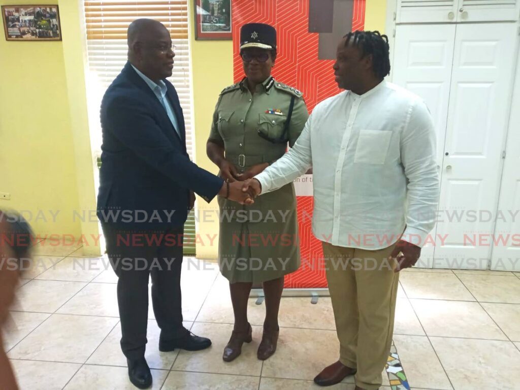 President of the Tobago Chamber of Industry and Commerce Curtis Williams, left, shakes hands with Minister in the Ministry of National Security Keith Scotland after a meeting to discuss crime on the island at the chamber's headquarters, ANSA McAL Building, Scarborough, on August 13. Looking on is Police Commissioner Erla Harewood Christopher. - Photo by Corey Connelly