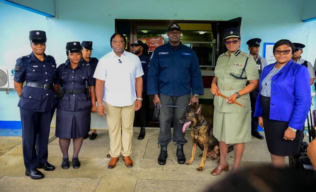 Minister in the Ministry of National Security Keith Scotland, third left, and CoP Erla Harewood-Christopher, second right, were accompanied by police officials and a member of the canine unit during a walkabout in Crown Point, Tobago, on August 12. - Visual Styles