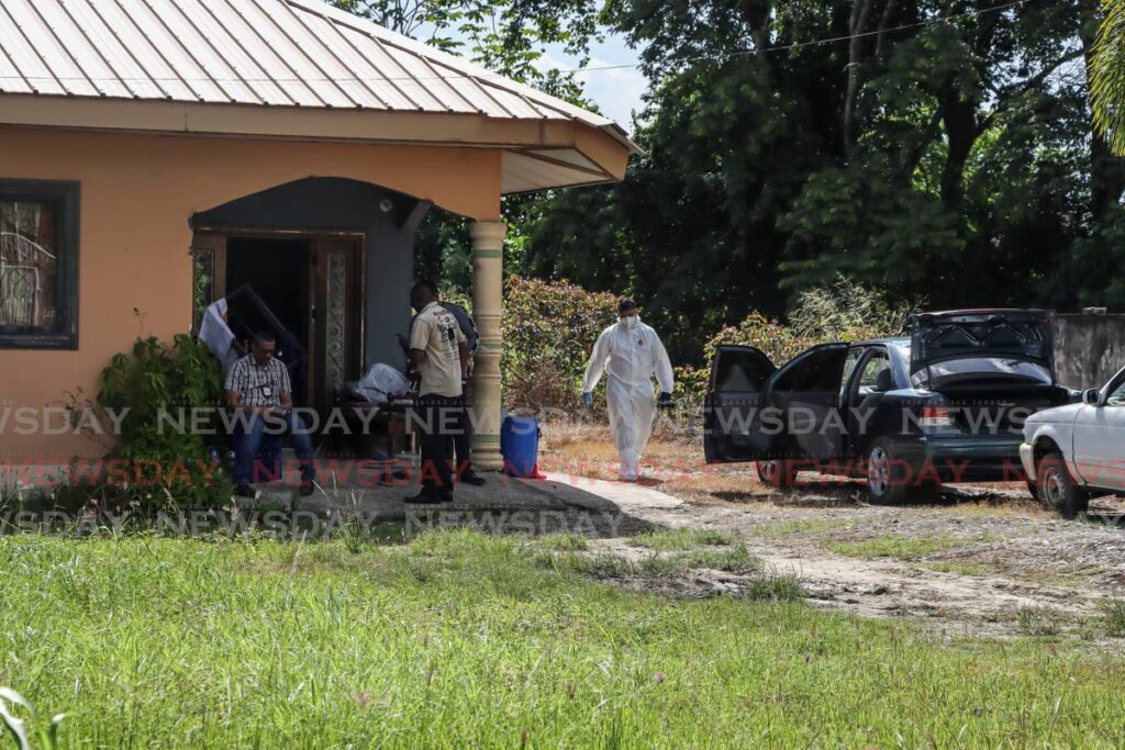 Police crime-scene investigators processing the scene at which police killed six people in at shootout at Razak Trace, Freeport, on August 14. - Photo by Venessa Mohammed