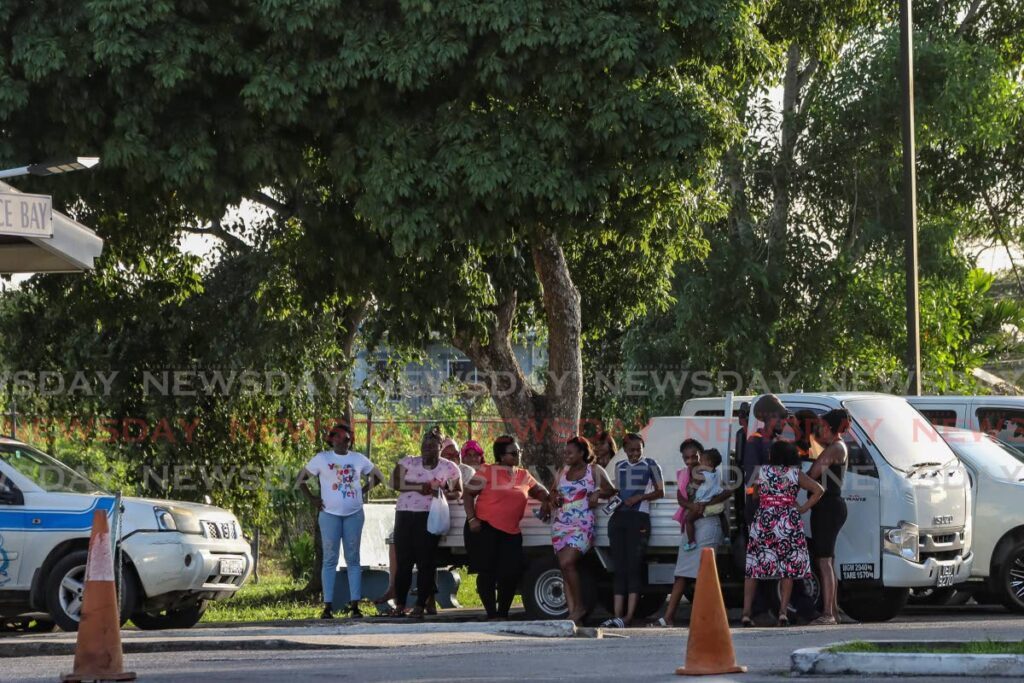 Relatives of Jovan Simon, who was one of six killed by police at a house on Razak Trace, Freeport, wait for information from the authorities at the Couva District Health Facility, Couva. on August 14. FILE PHOTO/VENESSA MOHAMMED - 