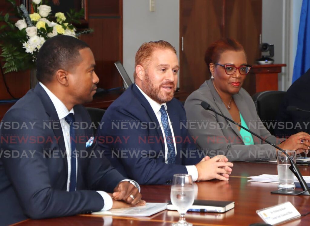 Ansa McAl CEO Anthony N Sabga III, centre, speaks to stockholders during a meeting at Tatil Building, Port of Spain, on August 16.He is flanked by group CFO Nicholas Jackman, left, and chief legal and external affairs officer Frances Bain-Cumberbatch.  - Photo by Ayanna Kinsale