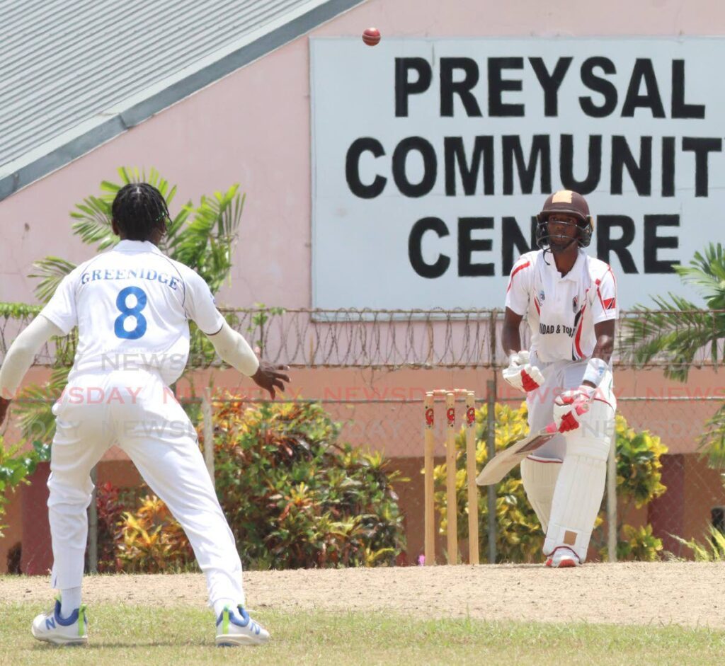 Barbados' Micah Greenidge of Barbados, left, looks to field the ball as TT batsman Christian Lall looks on during a CWI Rising Stars Under17 two-day match, at the Inshan Ali Park, Preysal on August 17. - Photo by Angelo Marcelle