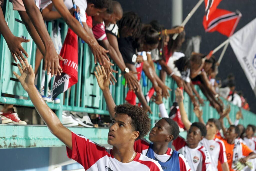 Thanks for coming out: Members of TT's Under-14 boys football team share a moment with spectators following their CFU Under-14 Boys Challenge Series win over St Kitts Nevis at the Dwight Yorke Stadium, Bacolet, Tobago on August 18. - Photo courtesy TTFA Media