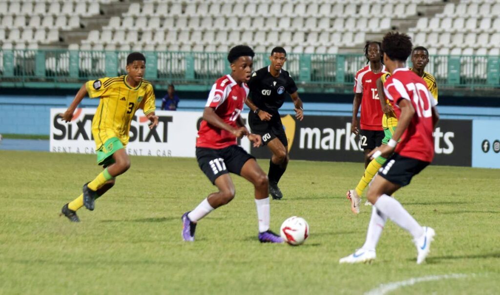 TT's Aaden Jones, centre, runs at the Jamaica defence during their tier one, group A match in the CFU Under-14 Boys' Challenge Series at the Dwight Yorke Stadium in Bacolet, Tobago on August 19. - Photo courtesy TTFA Media