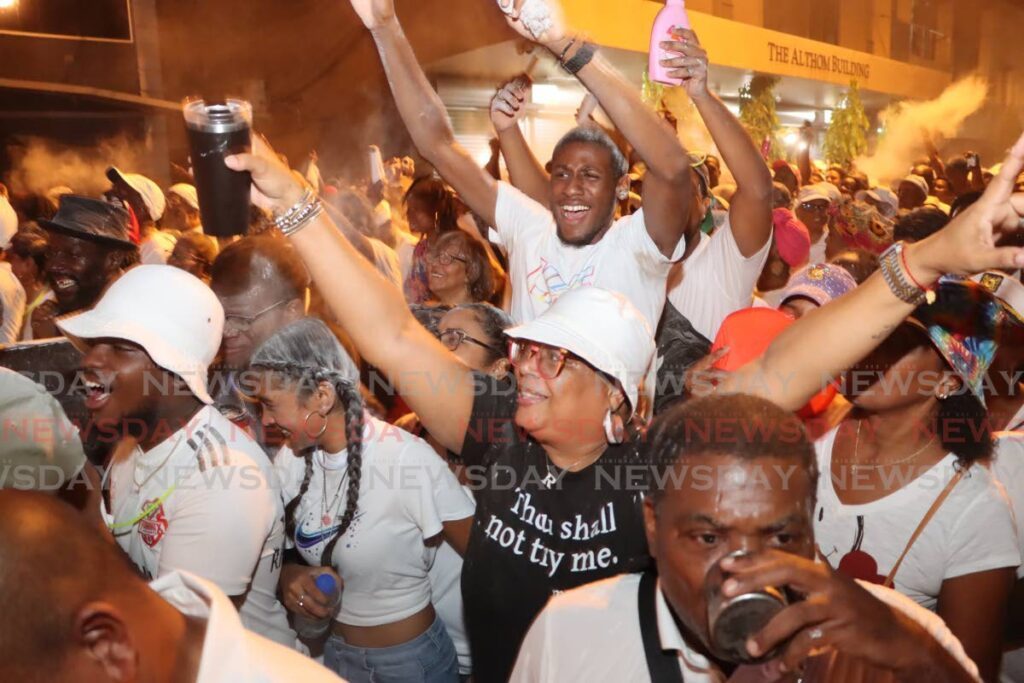 Pan lovers enjoy themselves during the Pan and Powder Parade at City Hall on Knox Street, Port of Spain. 